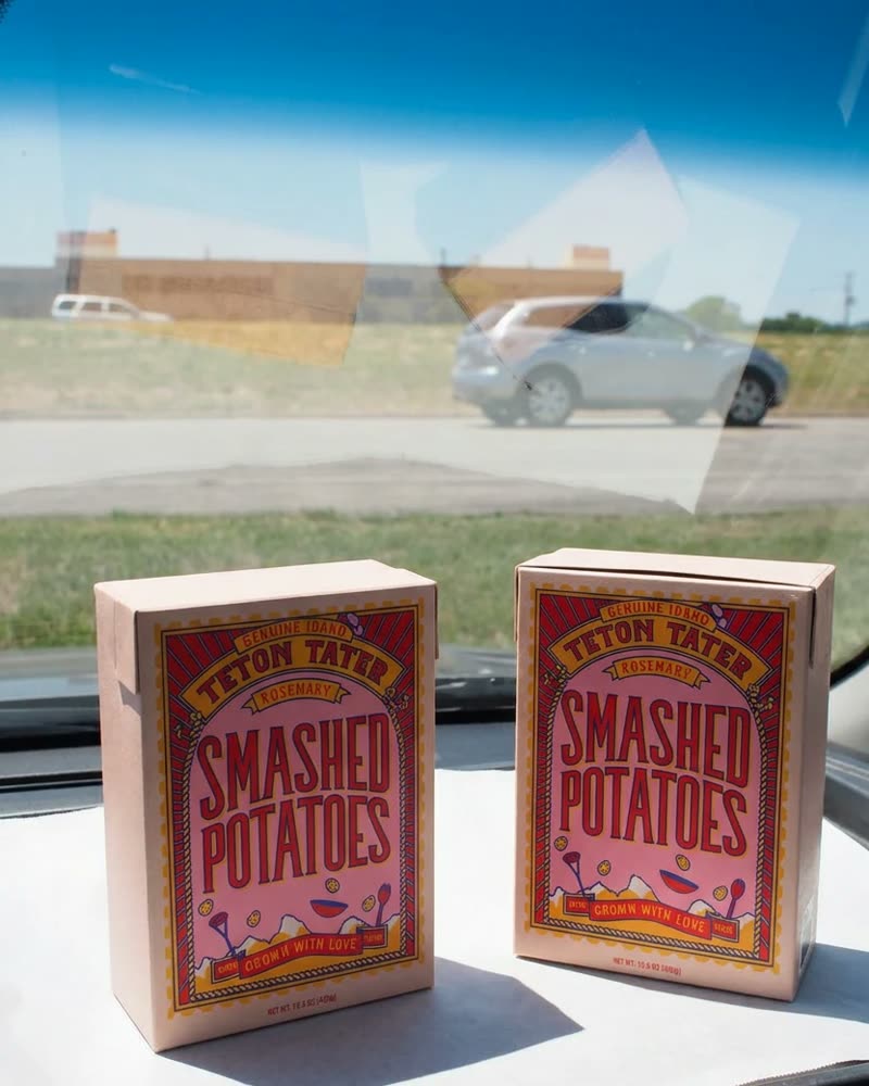 Two cartons of Teton Tater smashed potatoes on a car dashboard
